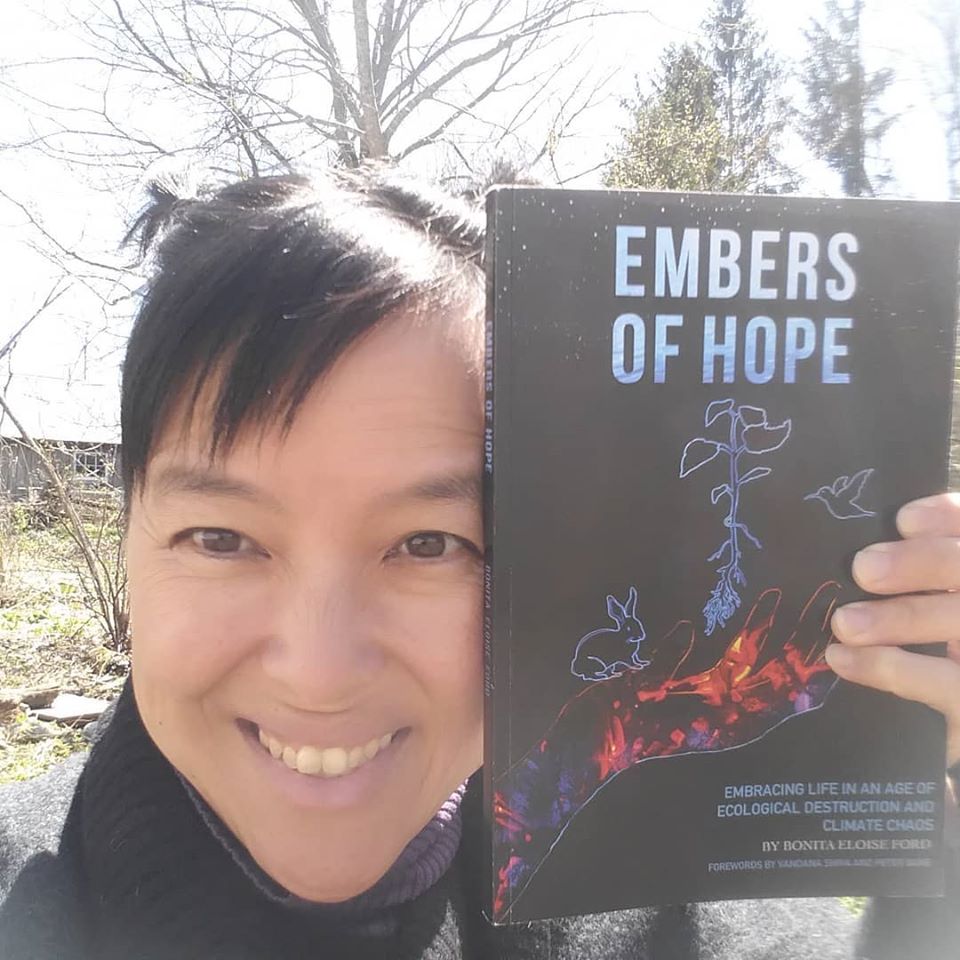author Bonita Eloise Ford holding her book "Embers of Hope: Embracing Life in an Age of Ecological Destruction and Climate Chaos"