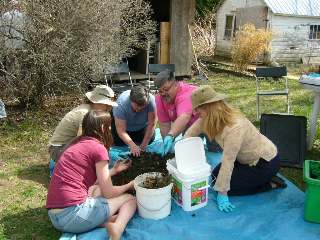 Workshop students harvesting worm castings
